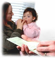 Mother and sick child waiting for a prescription to be signed